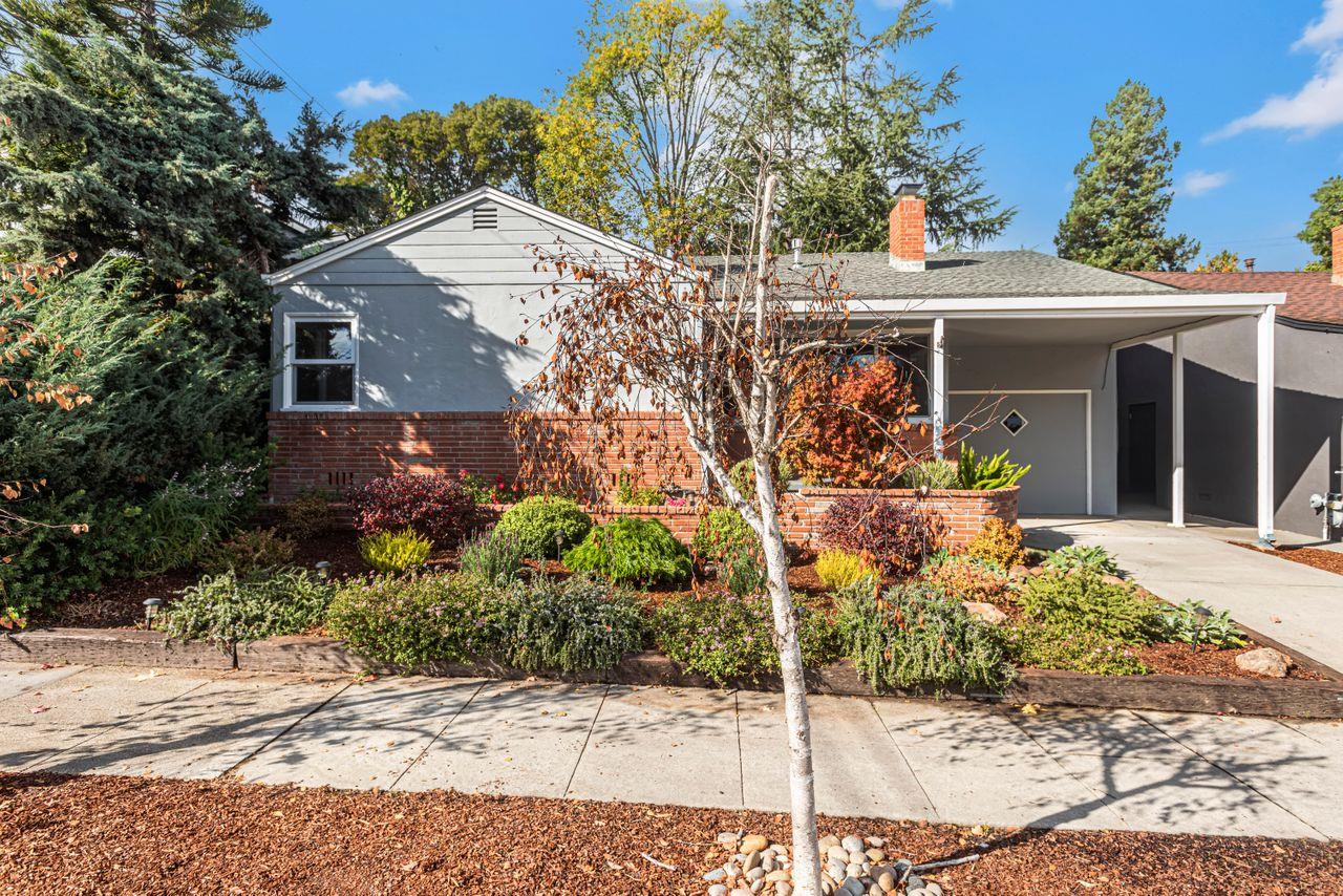 a front view of a house with garden