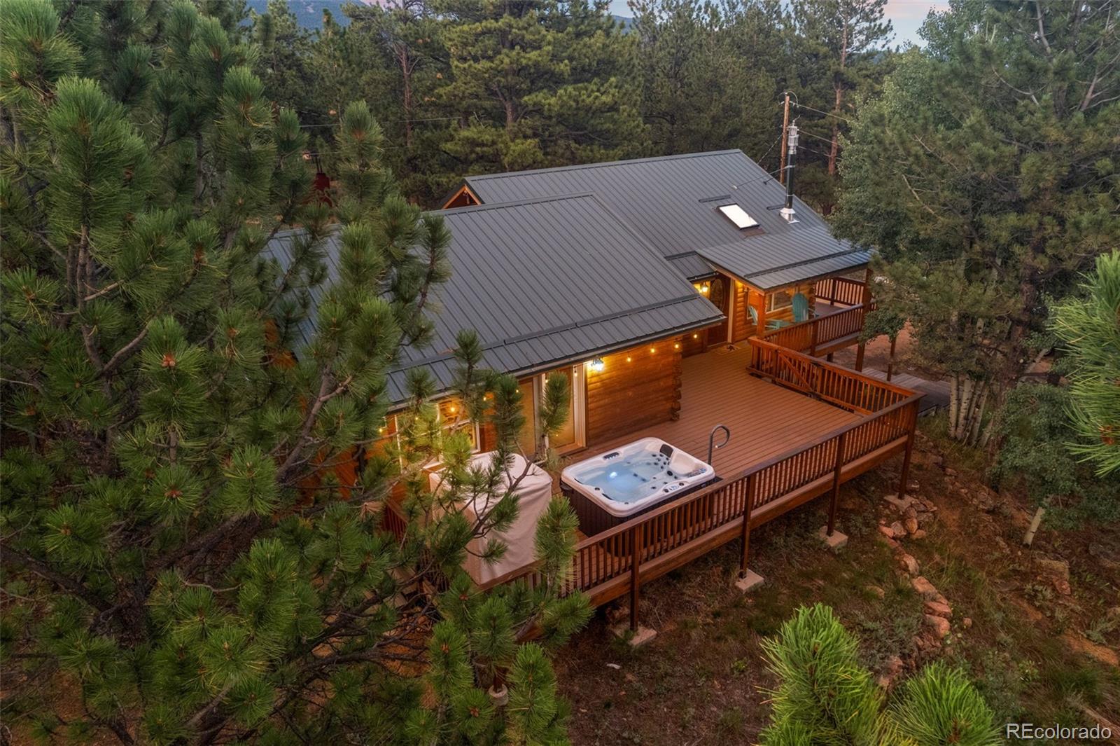 an aerial view of a house with roof deck outdoor seating and yard