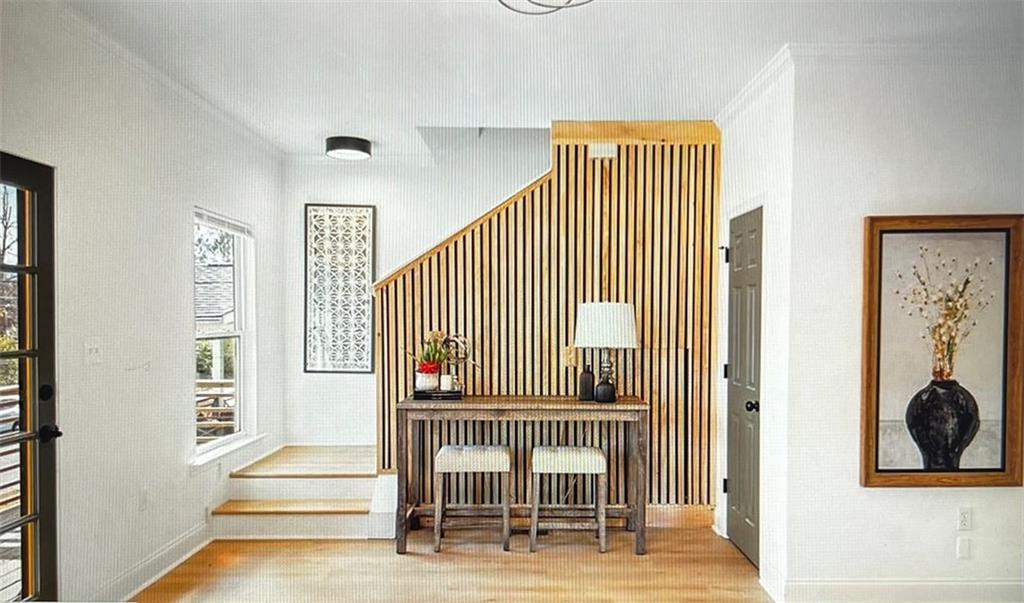 a view of entryway and hall with wooden floor