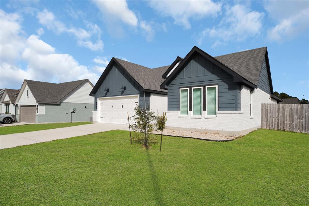 a front view of house with yard and green space