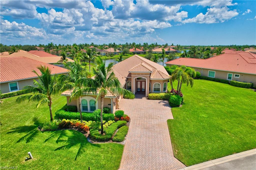 a front view of a house with a yard and fountain