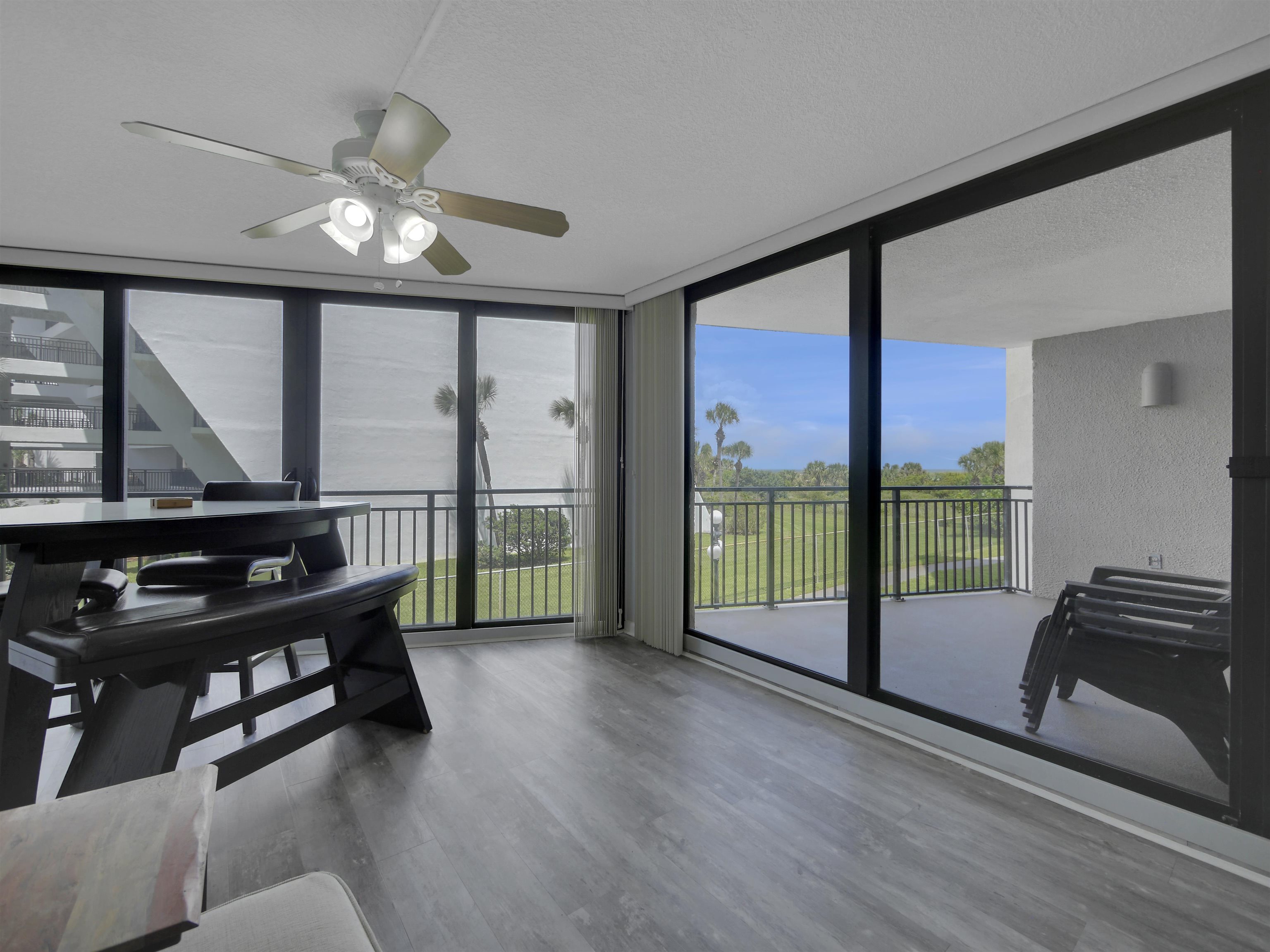 a view of a room with furniture and floor to ceiling window