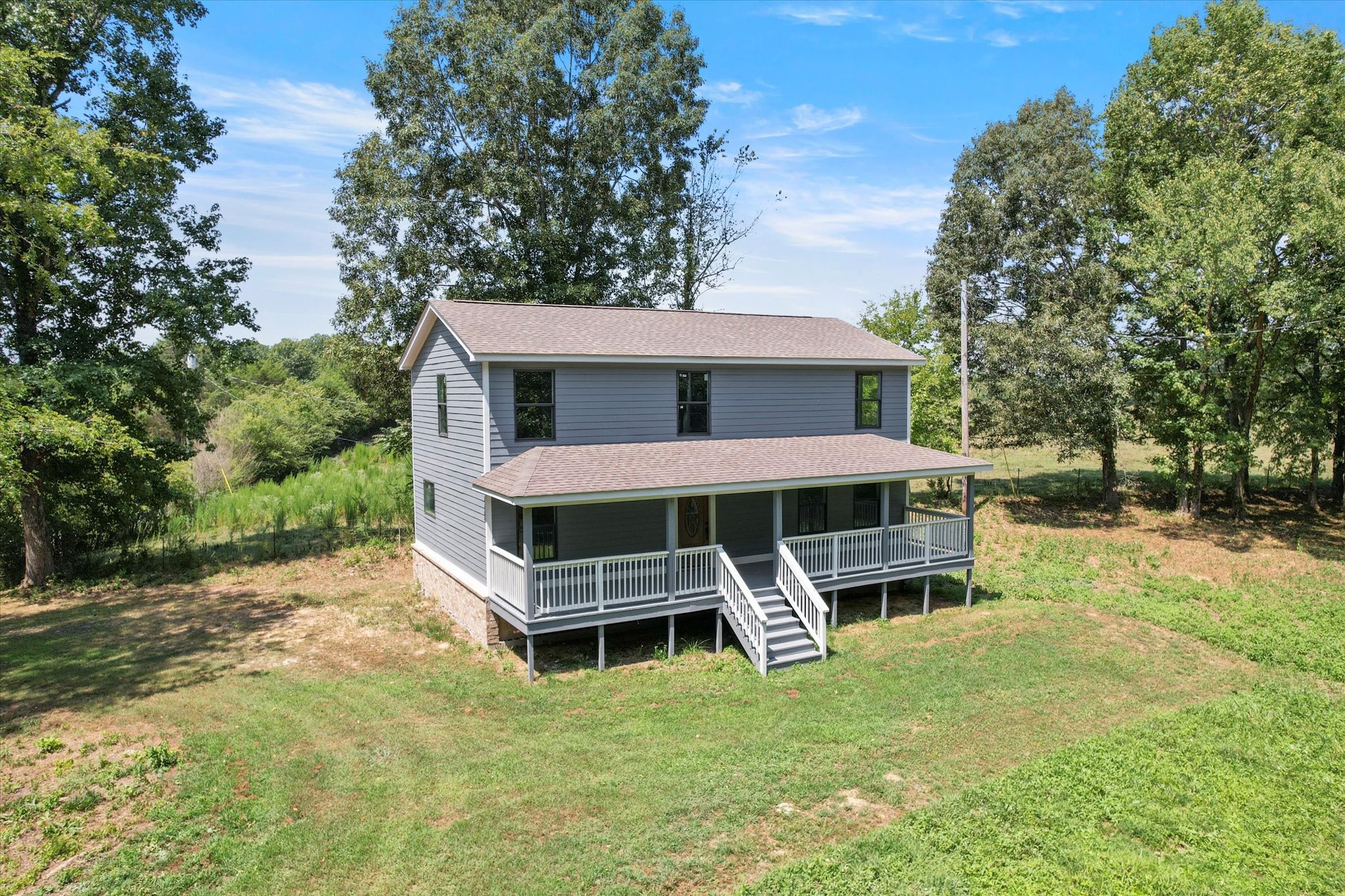 a view of a house with a yard and sitting area