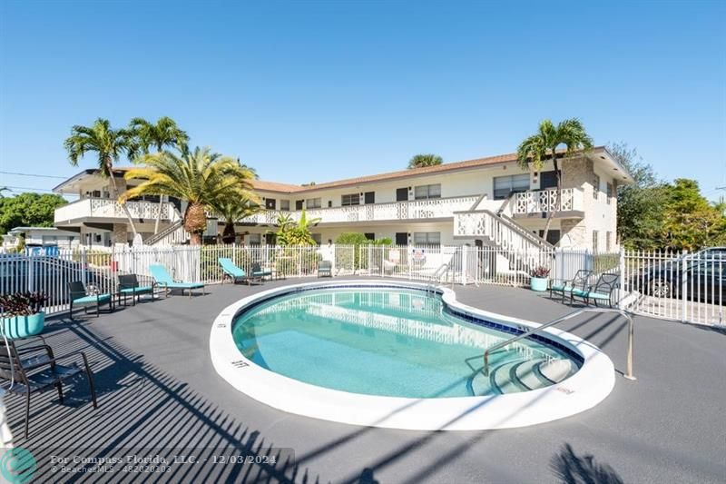 a view of a swimming pool with outdoor seating