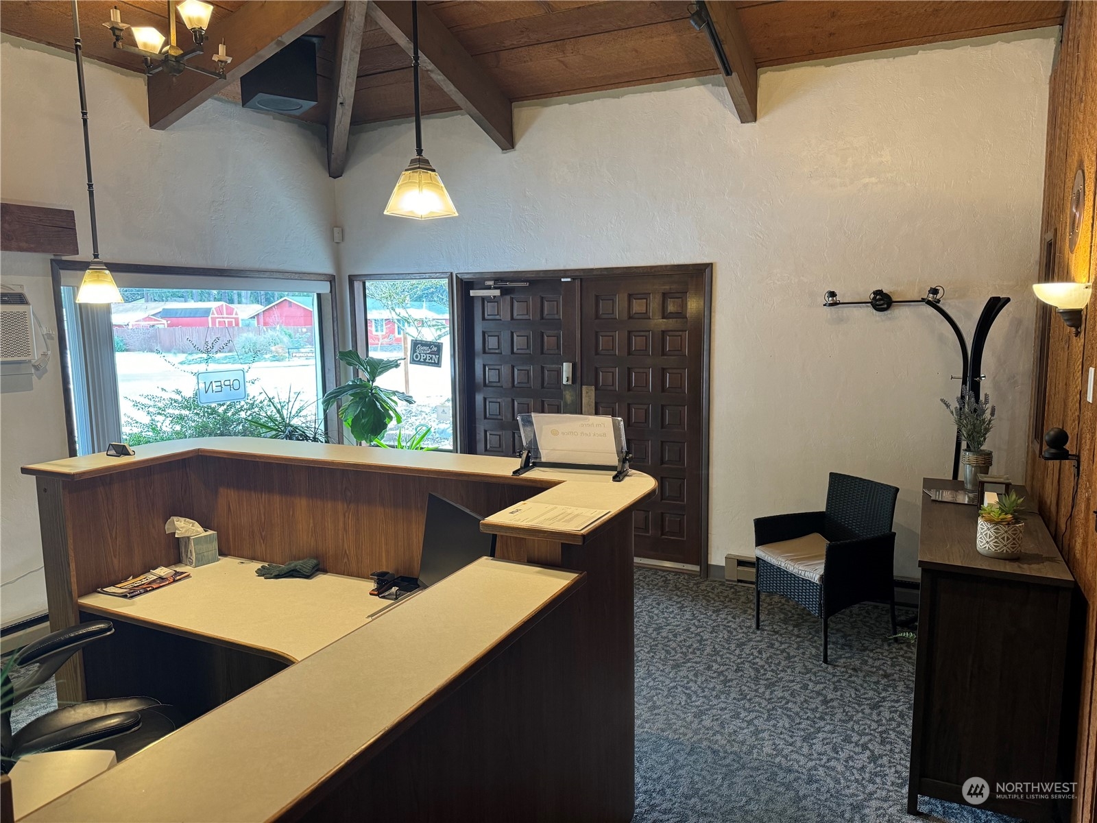 a view of a dining room with furniture a chandelier and wooden floor