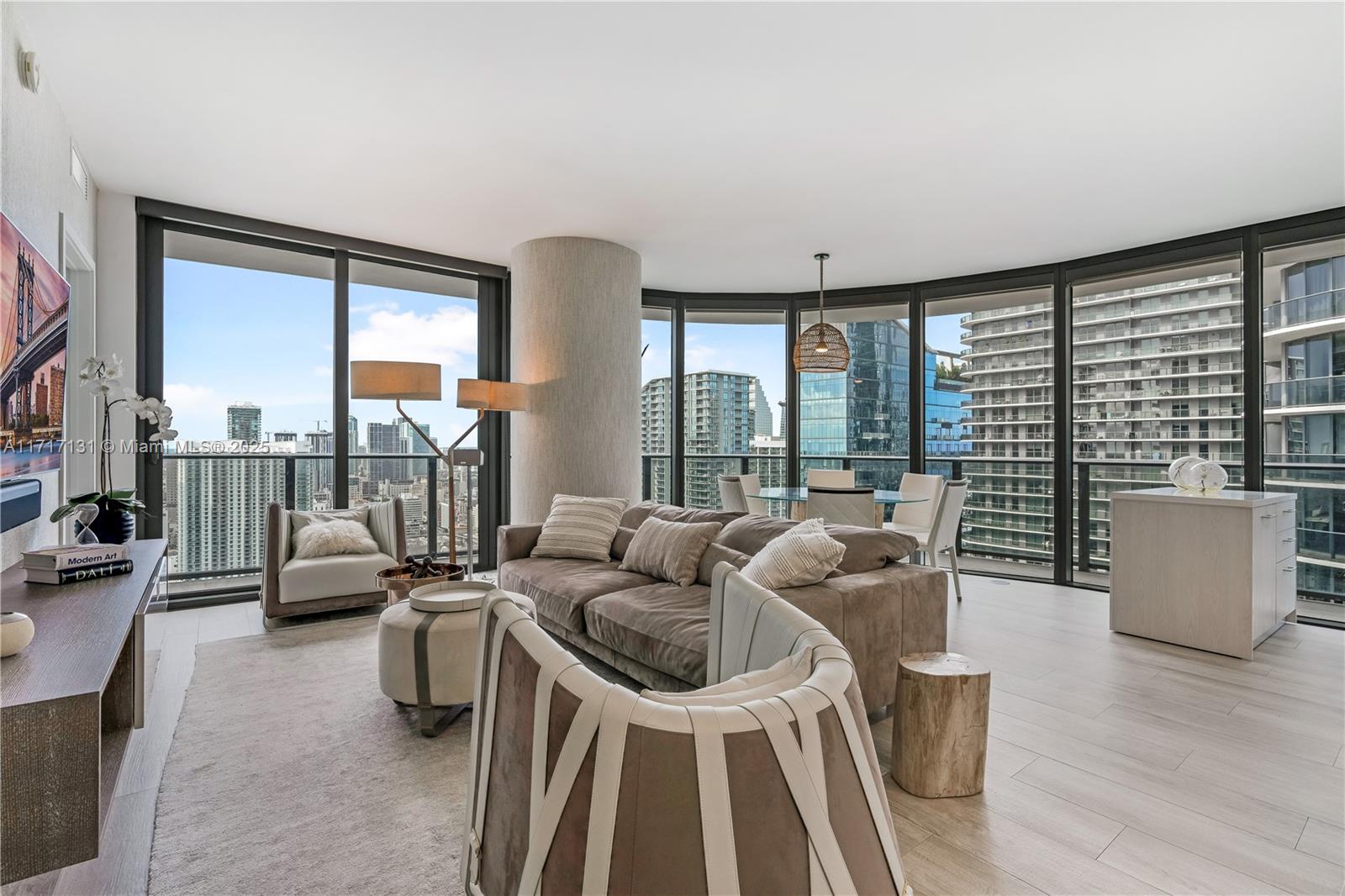 a living room with furniture and floor to ceiling windows