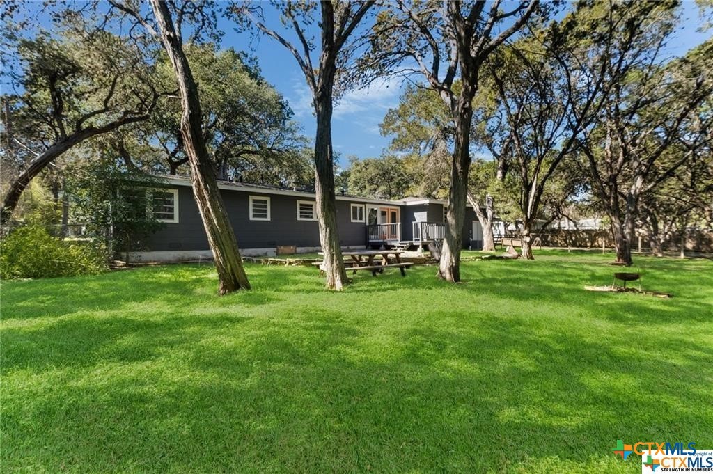 a view of a house with a backyard