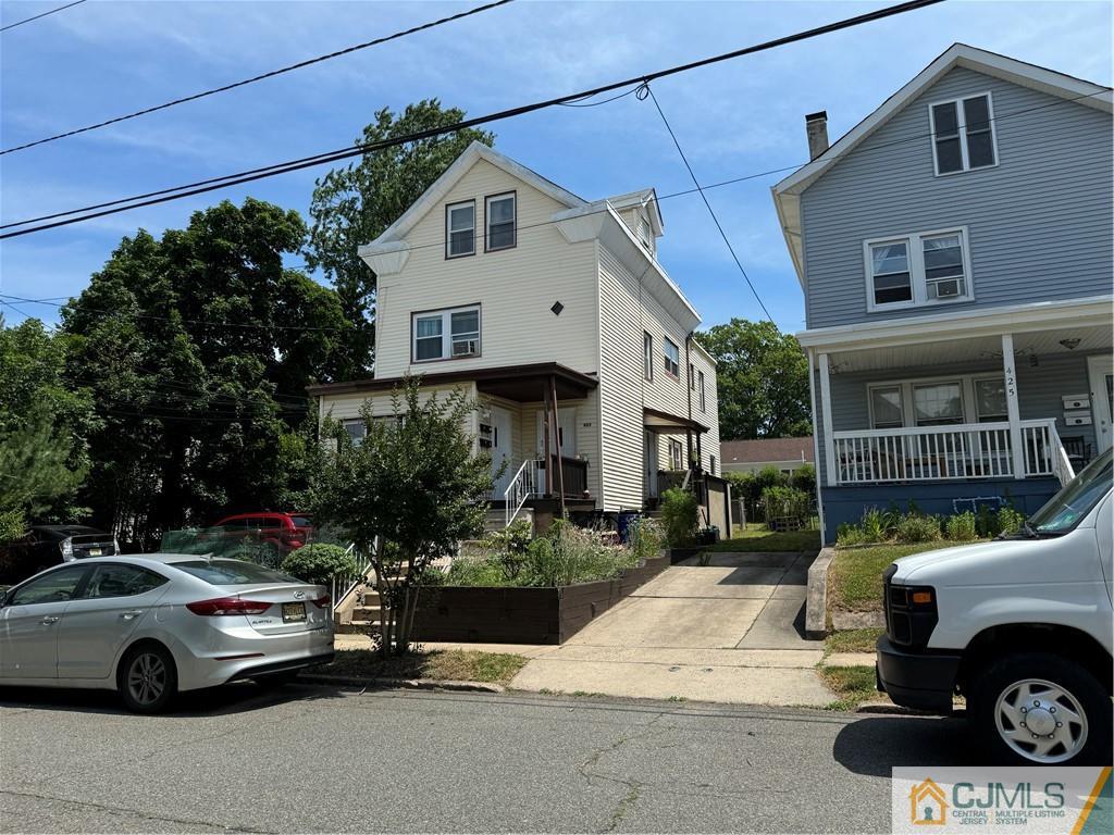 a front view of a house with parking space