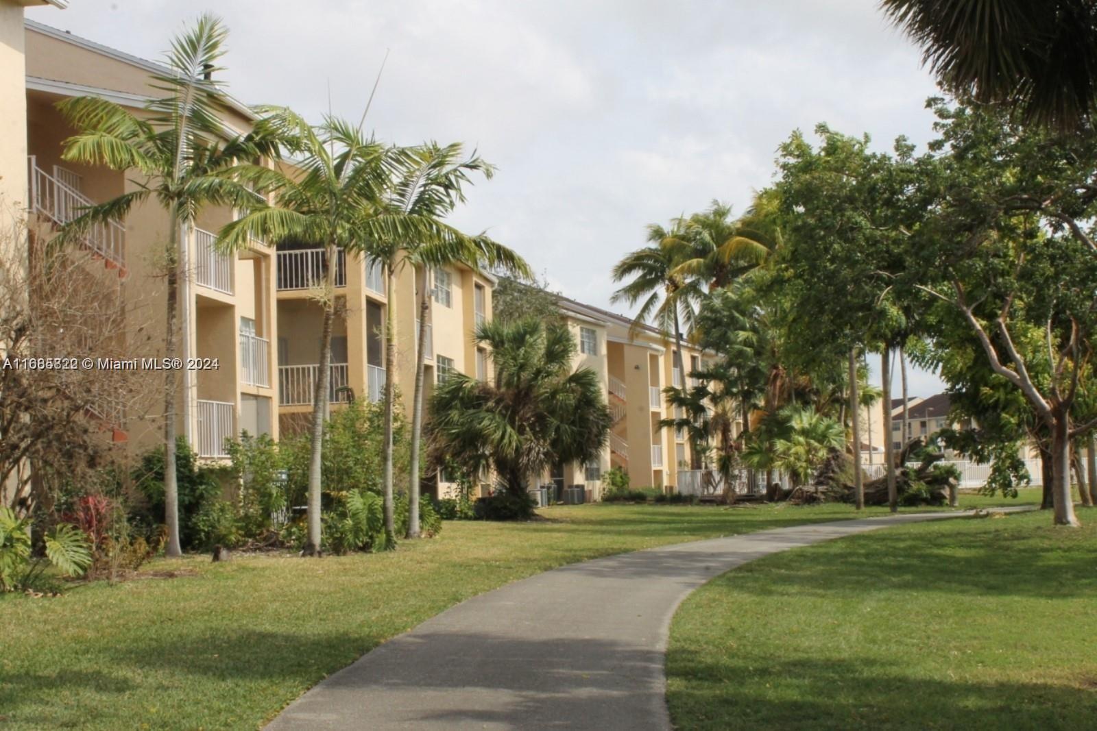 a front view of a building with a garden