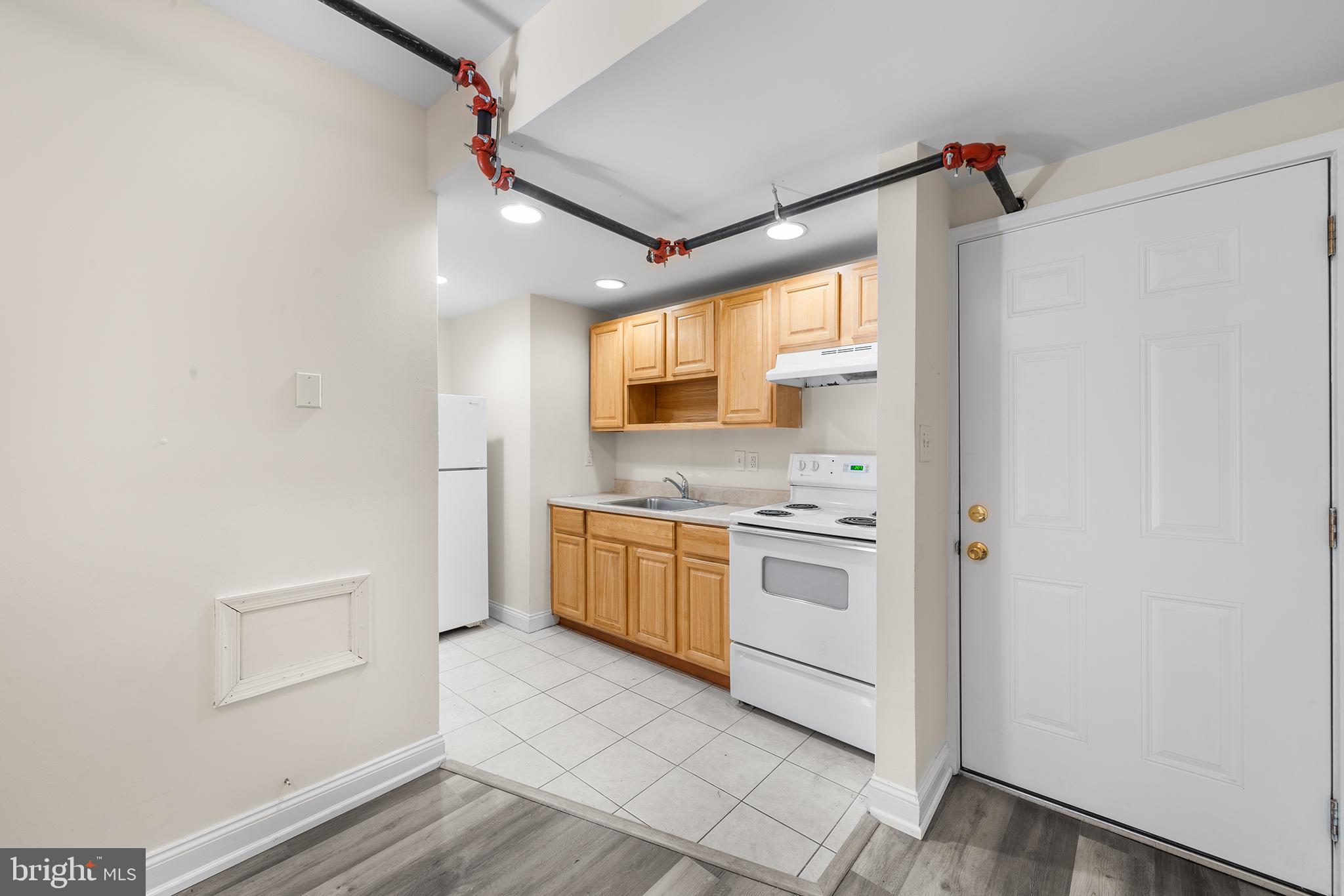 a kitchen with white cabinets and white appliances