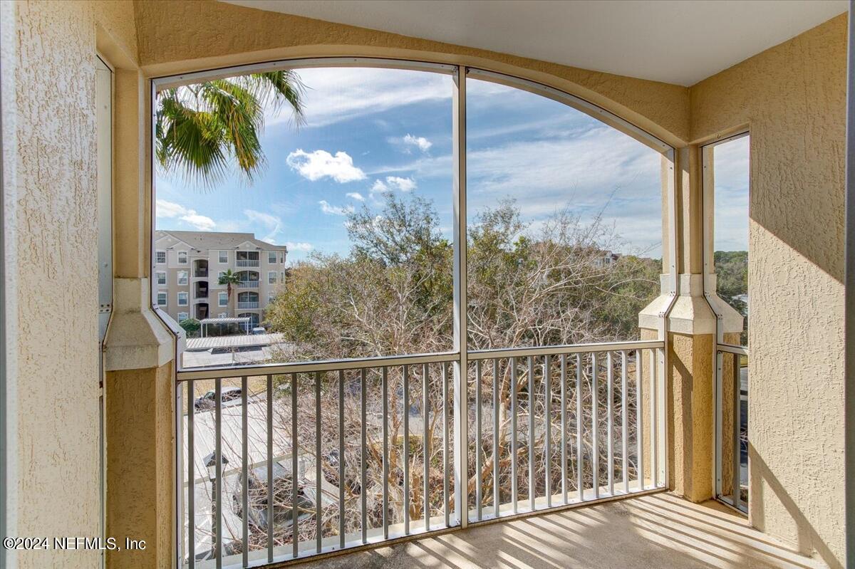 a view of a balcony with a tree