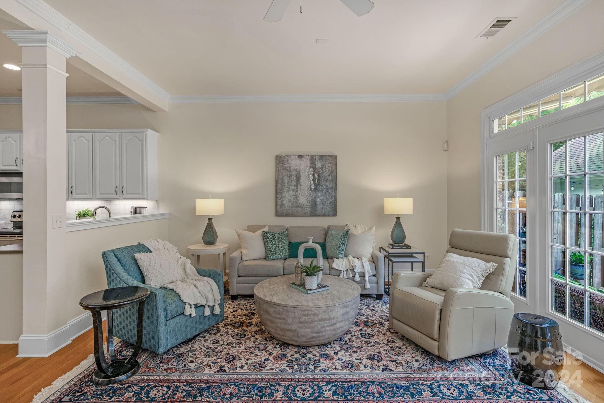 a living room with furniture and a potted plant