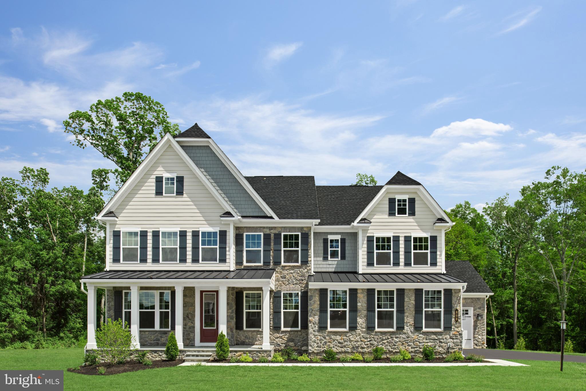 a front view of a residential houses with yard and green space