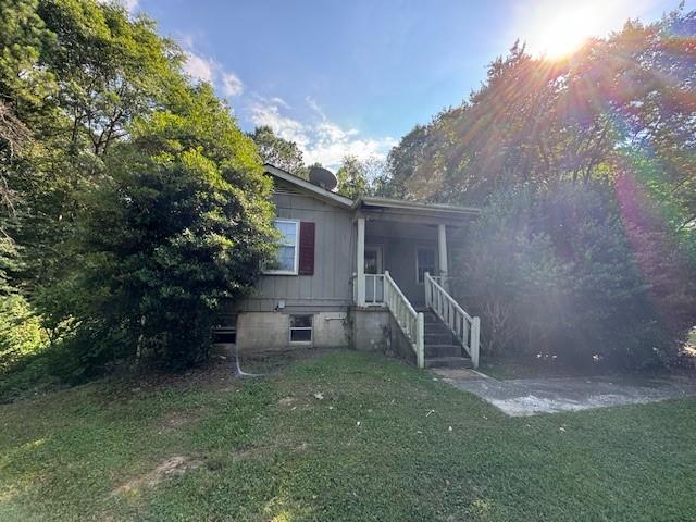 a view of a house with backyard and a tree