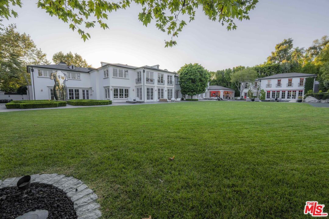 a view of a house with a backyard