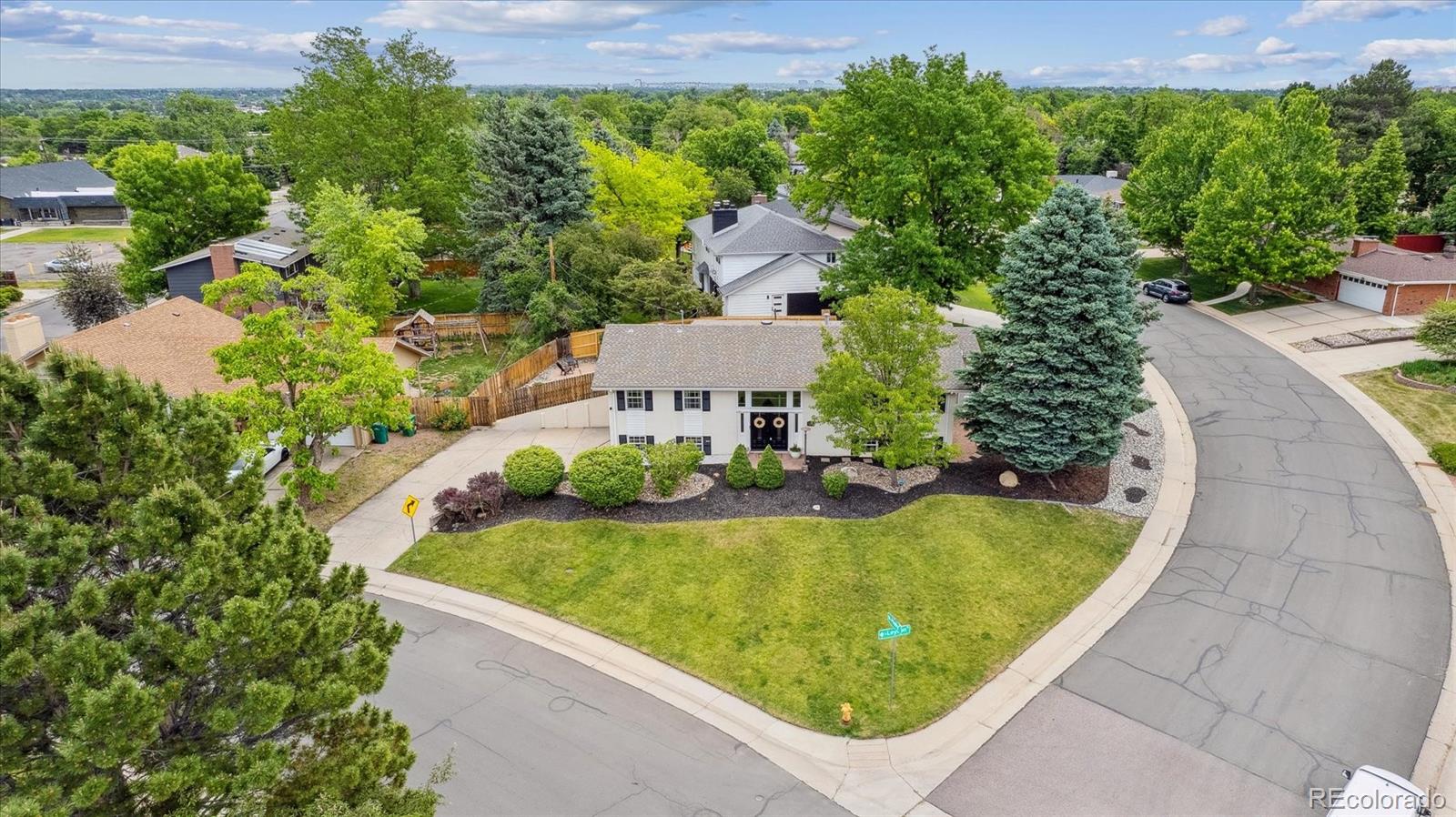 an aerial view of a house with swimming pool and garden