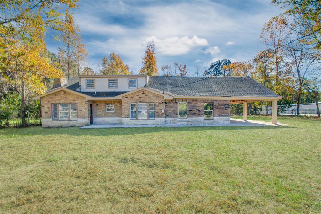 a front view of a house with a garden and deck