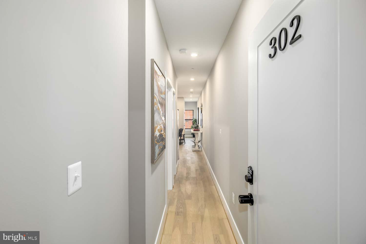 a view of a hallway with a white door