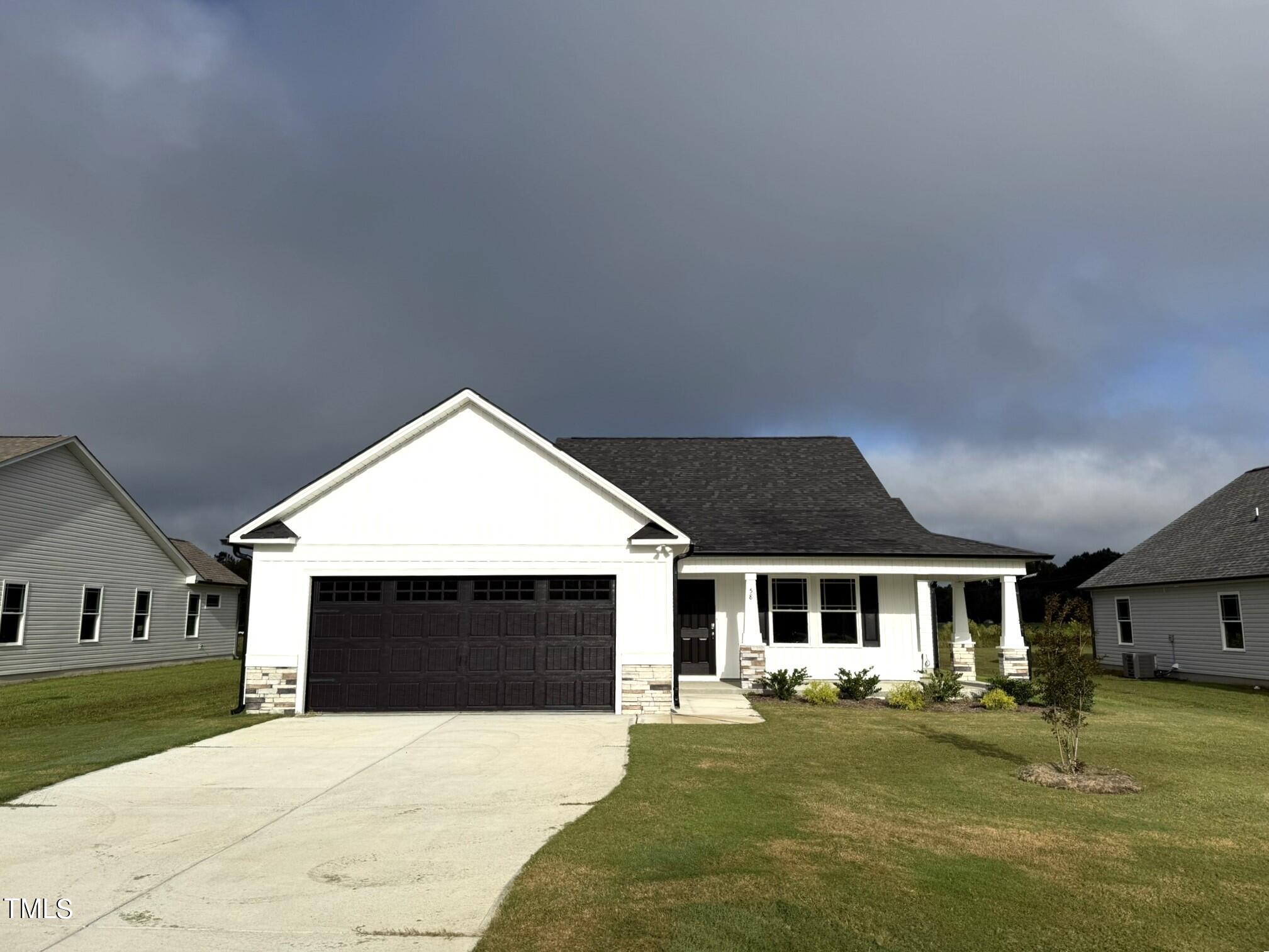 a front view of a house with a garden and porch