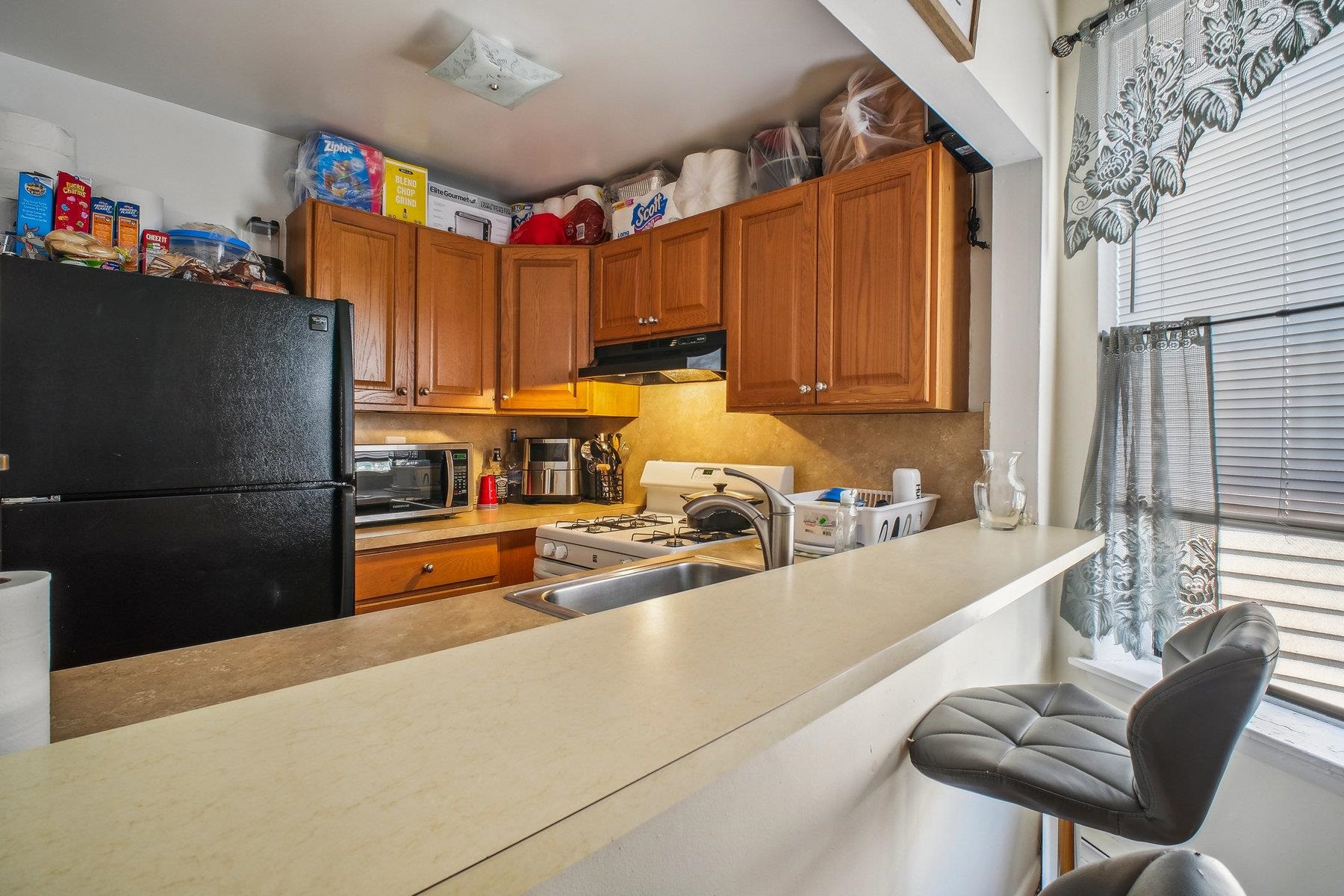 a kitchen with stainless steel appliances granite countertop a refrigerator and a sink