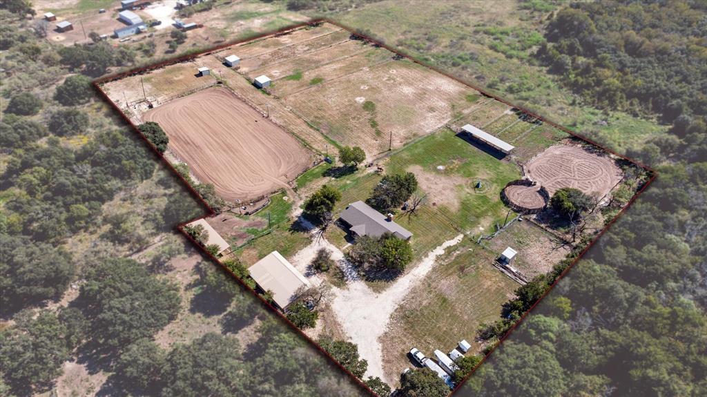 an aerial view of a house with a yard