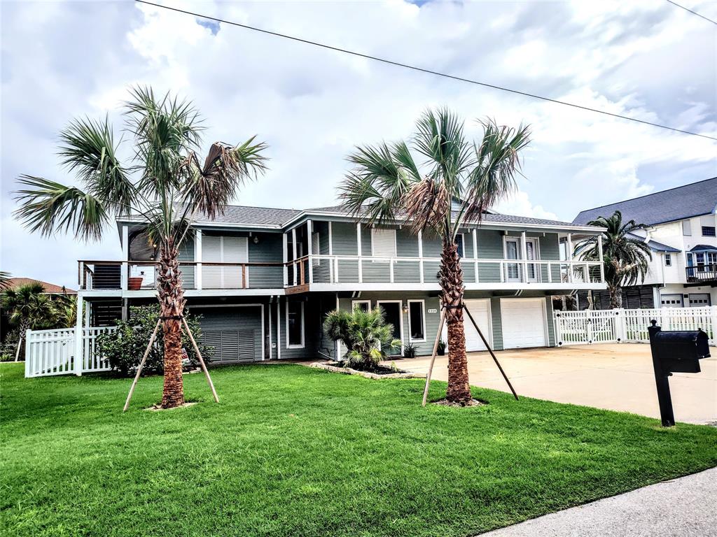 a front view of a house with a yard and swimming pool