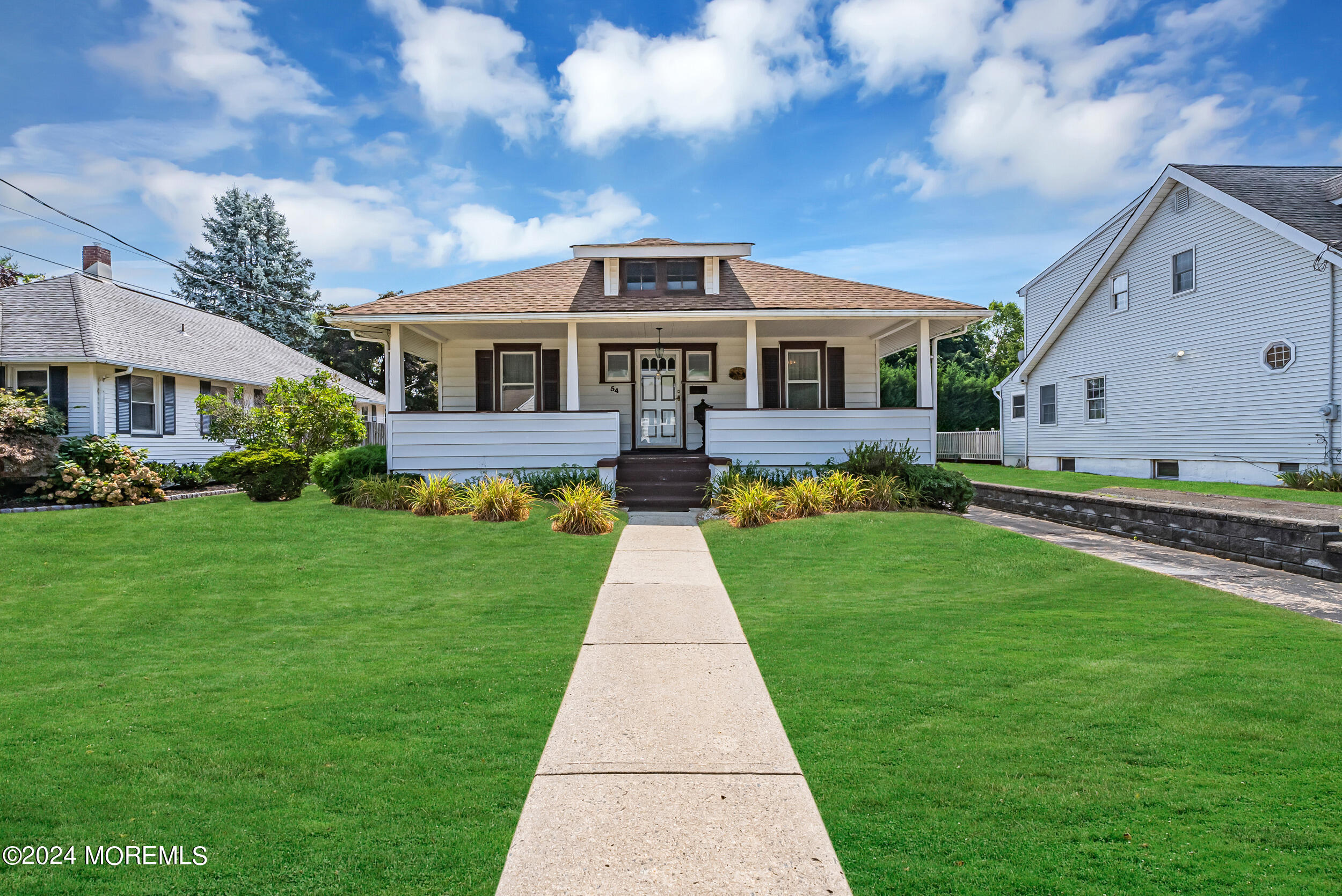 a front view of house with yard and green space