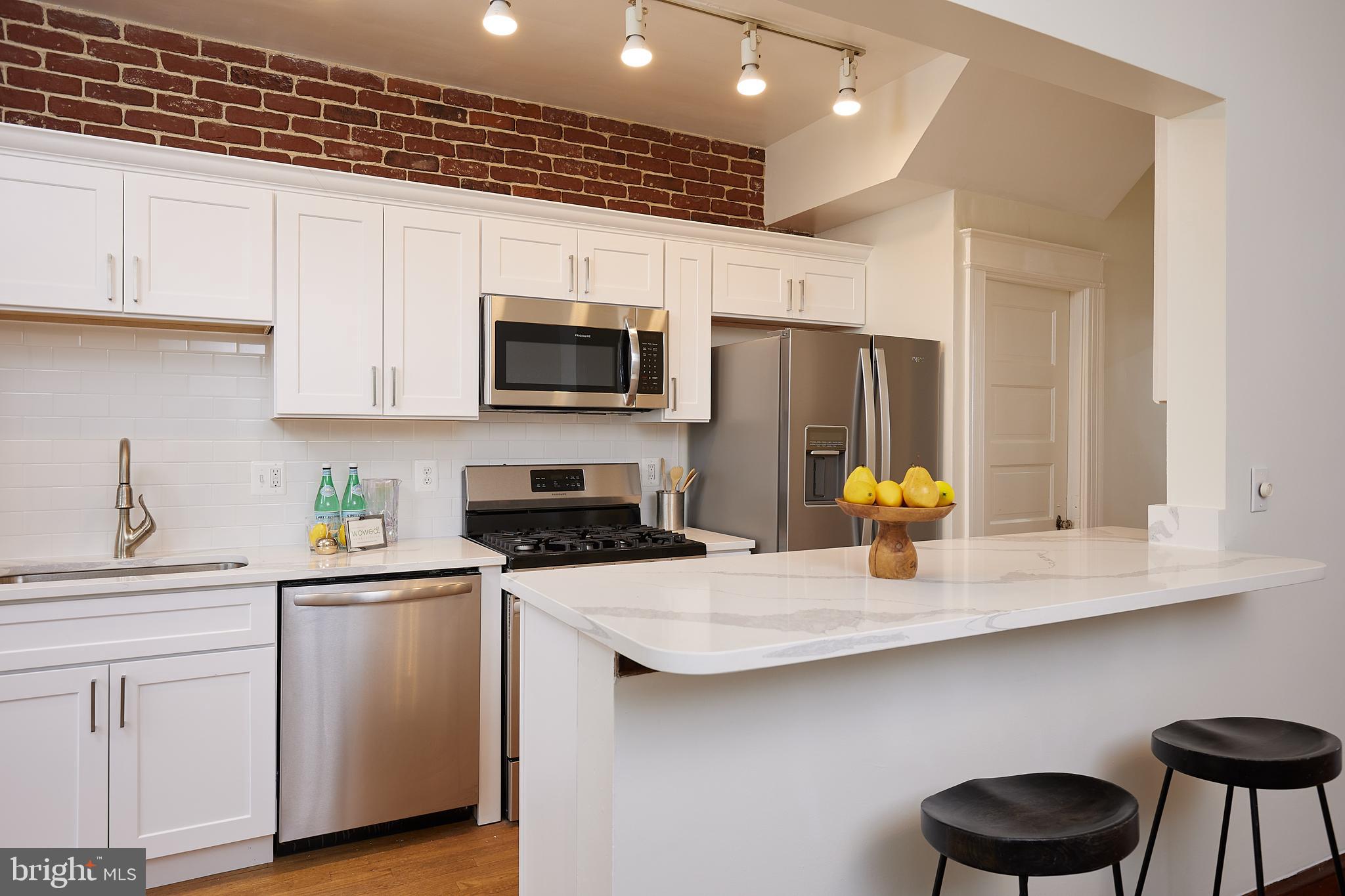 a kitchen with a sink a stove and cabinets