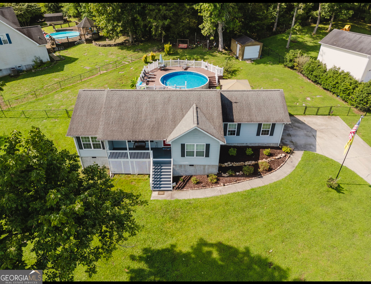 an aerial view of a house with swimming pool garden and patio