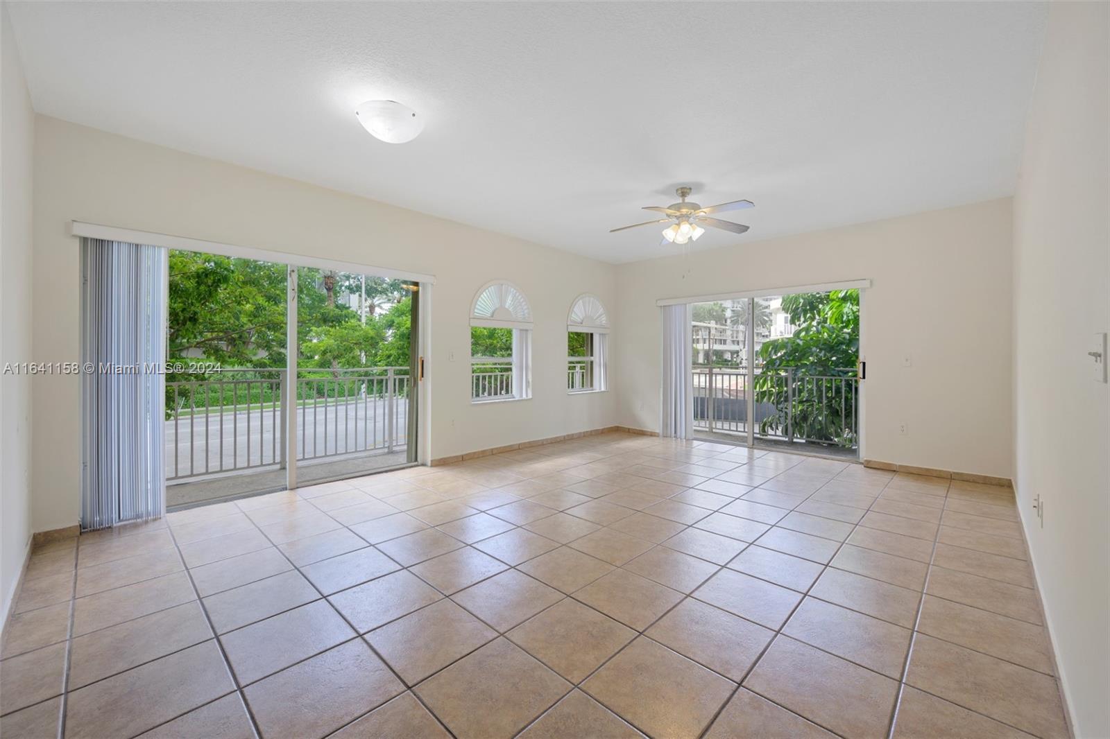 a view of a livingroom with an empty space and a balcony