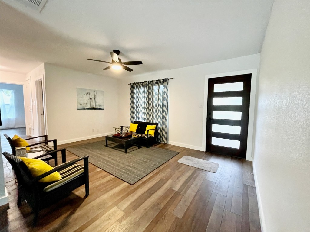 a living room with furniture and wooden floor