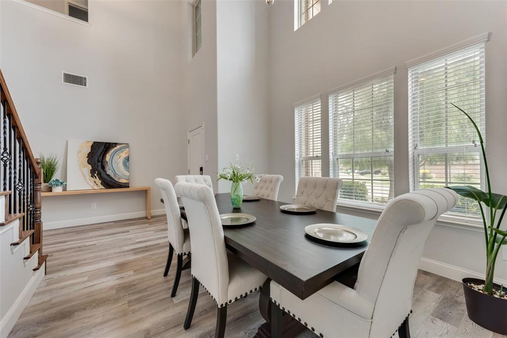 a view of a dining room with furniture large windows and wooden floor