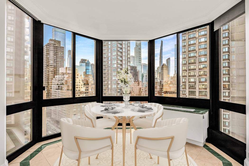 a dining room with large windows and wooden floor