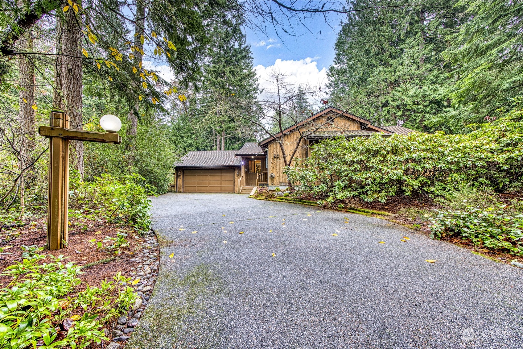 a pathway of a house with large trees