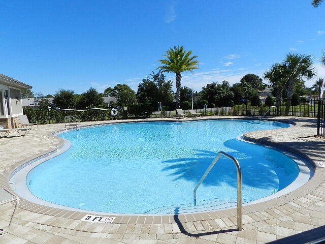 a view of a swimming pool with lounge chair