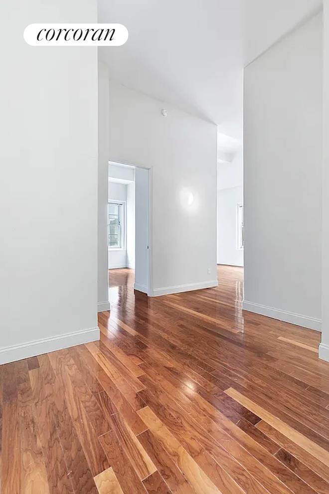 a view of a room with wooden floor