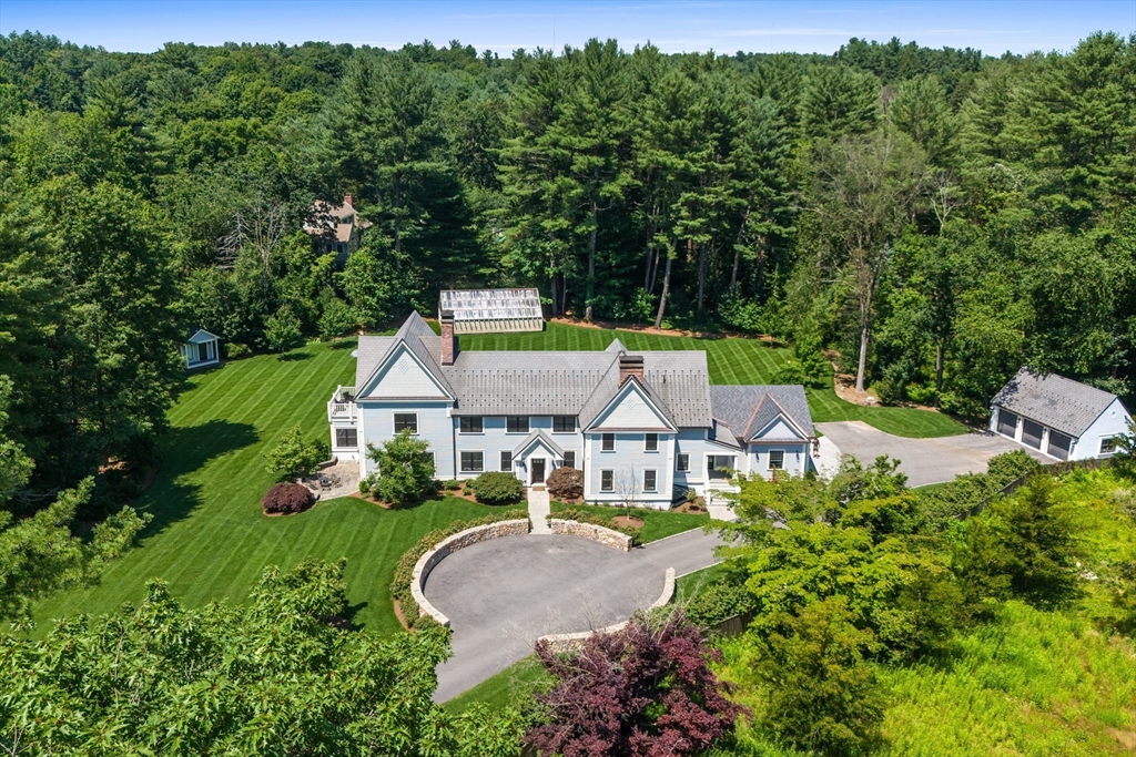 a aerial view of a house with swimming pool and garden