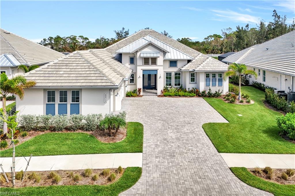 View of front of home featuring french doors and a front lawn