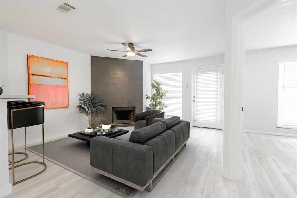 a living room with furniture a dining table and a window