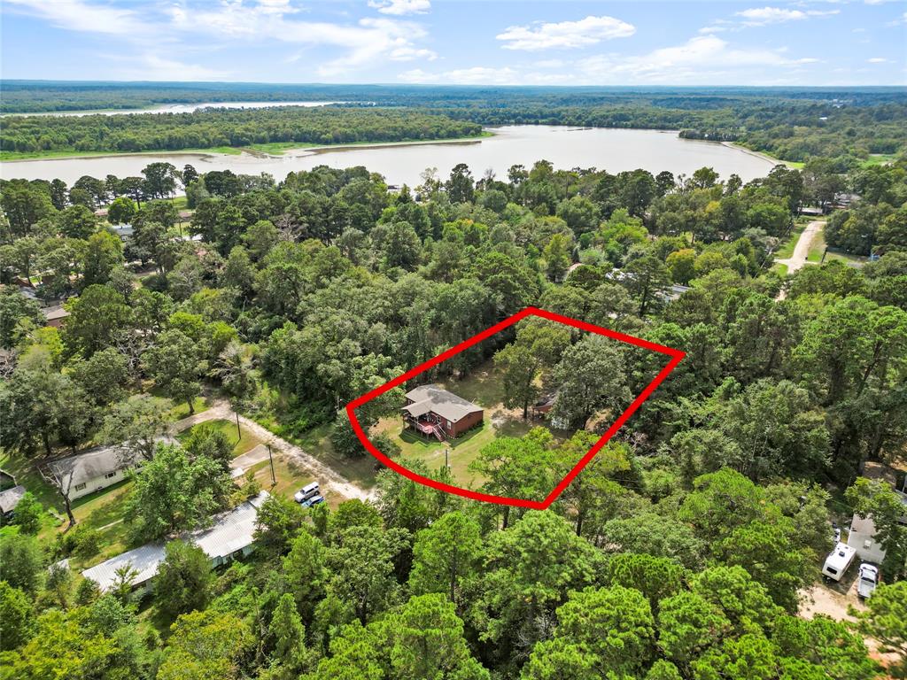 an aerial view of a golf course with a lake view