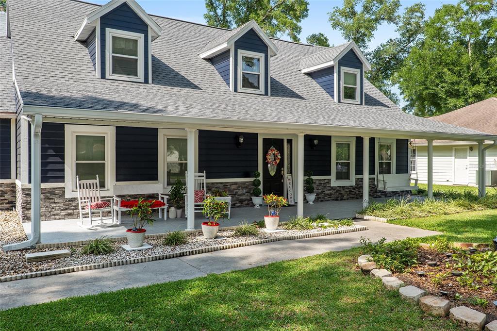 a front view of a house with a yard and porch