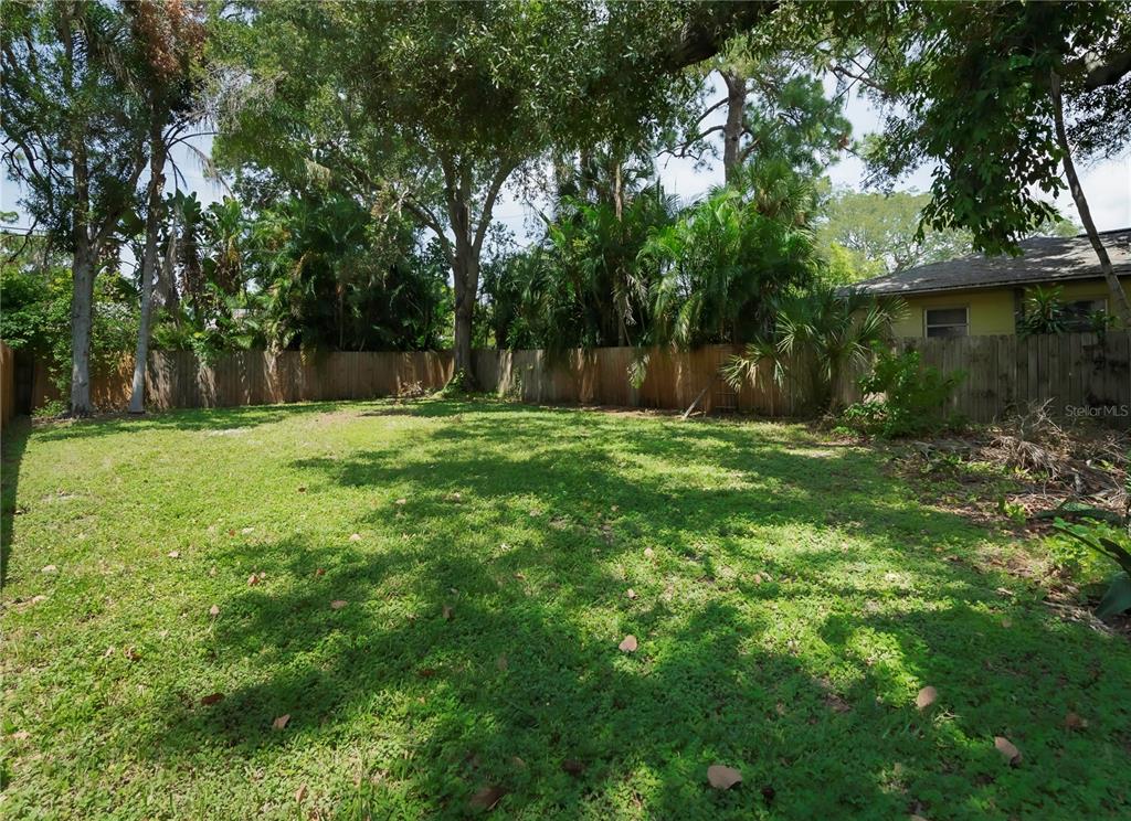 a backyard of a house with lots of green space