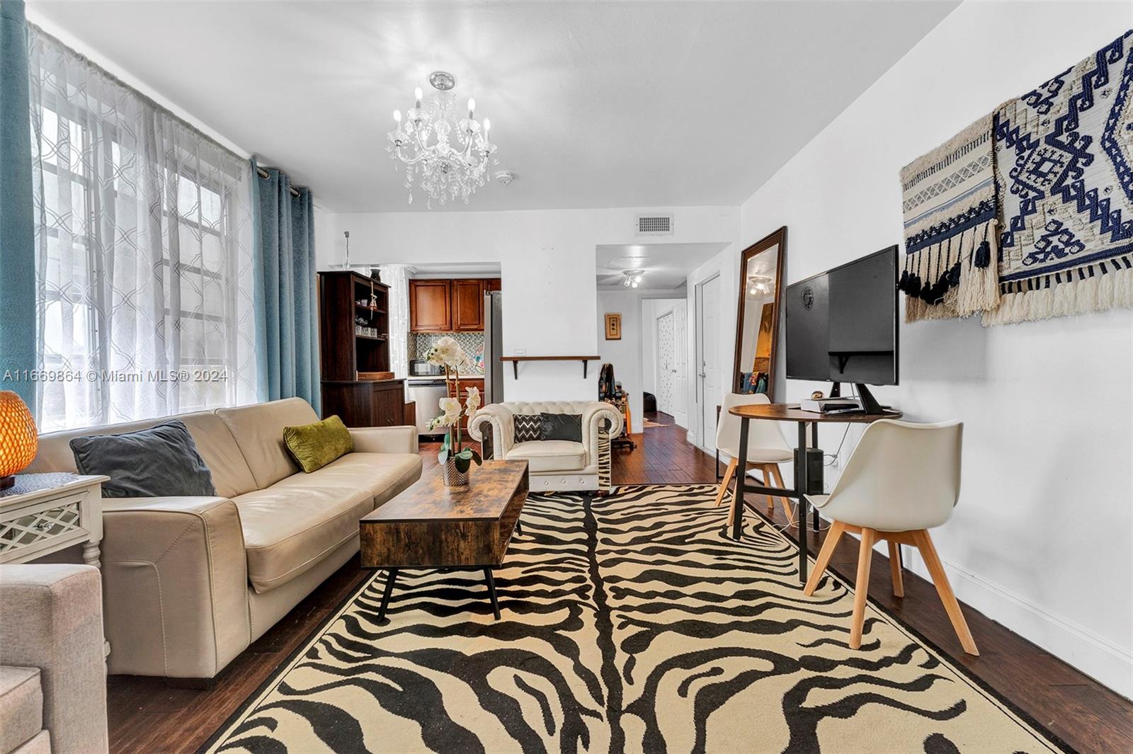 a living room with furniture and a chandelier