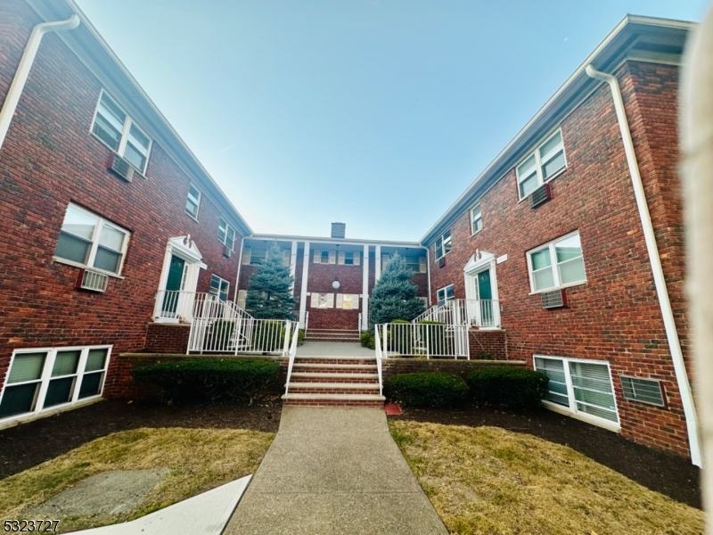 a view of a brick building next to a yard