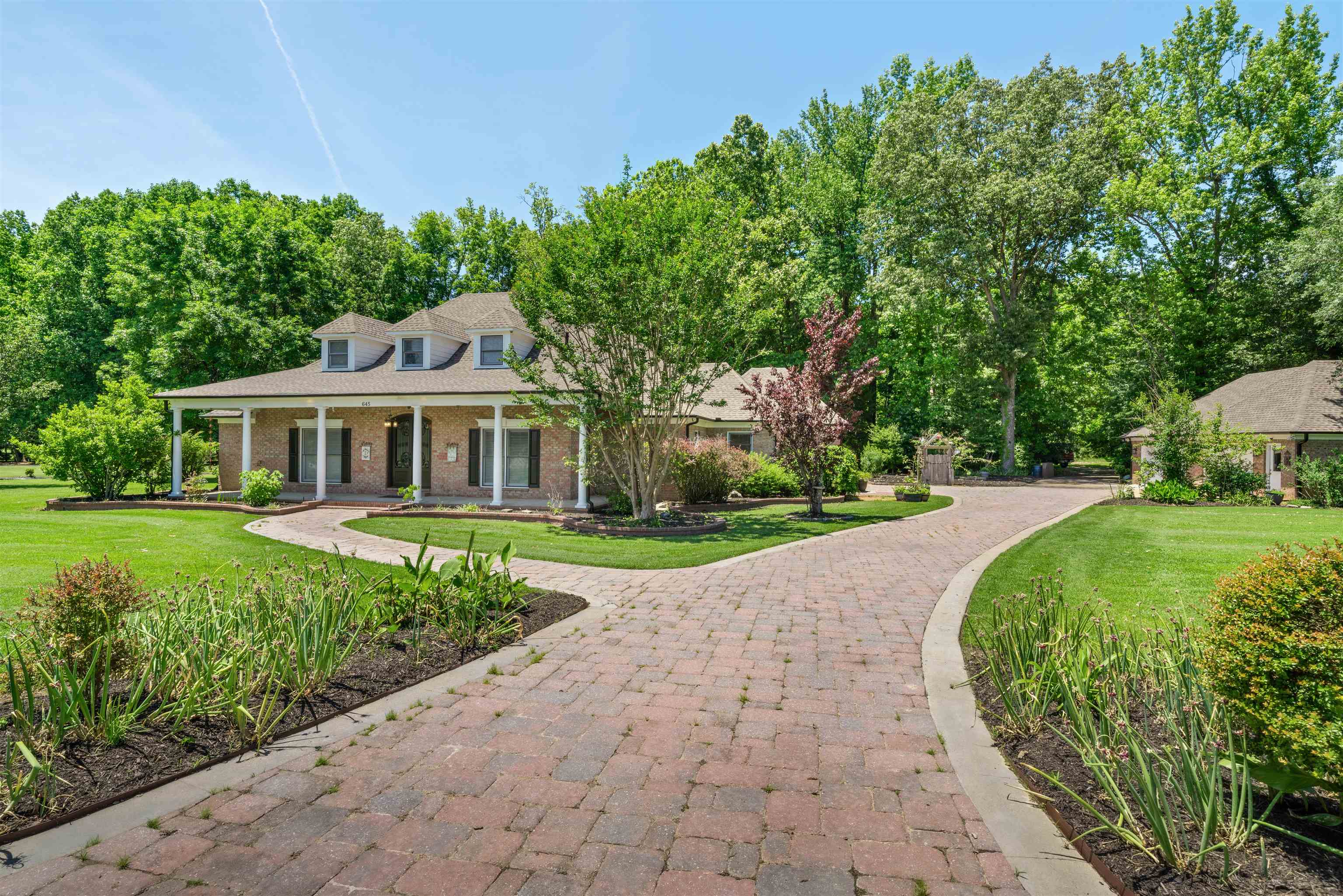 a front view of a house with garden