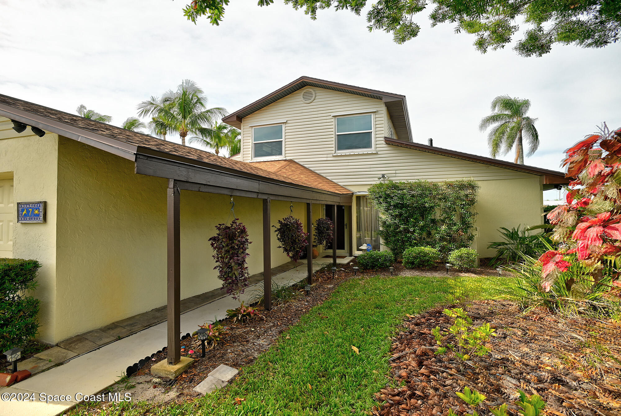 a view of a house with a yard and sitting area