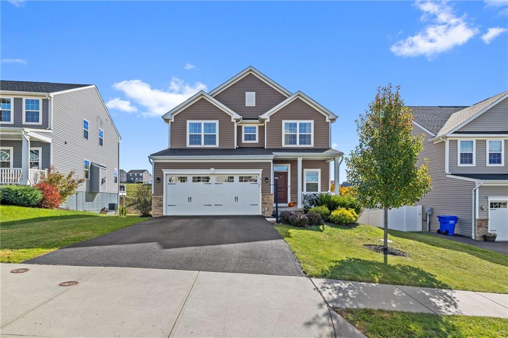 a front view of a house with a yard and garage