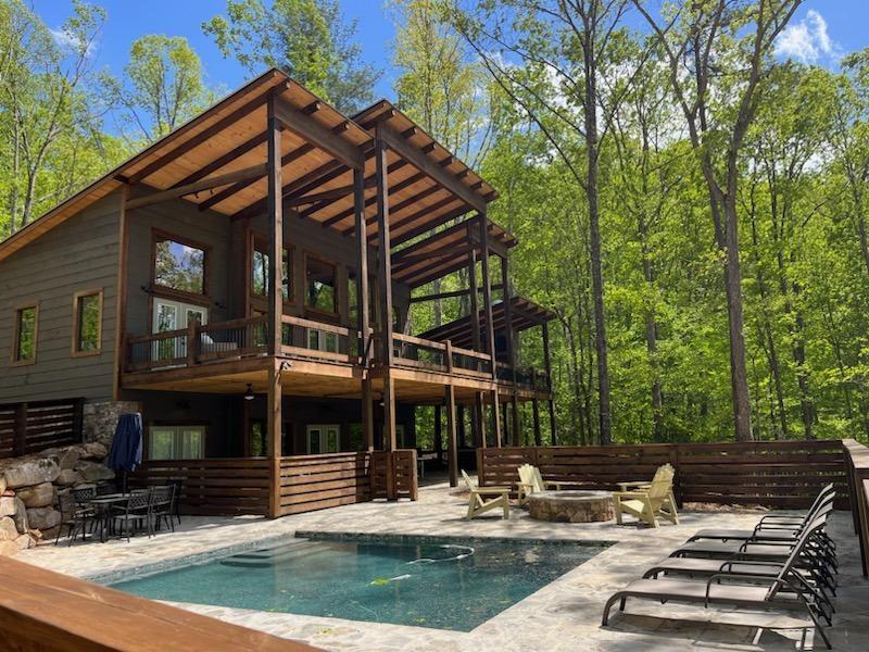 a view of a house with backyard porch and sitting area