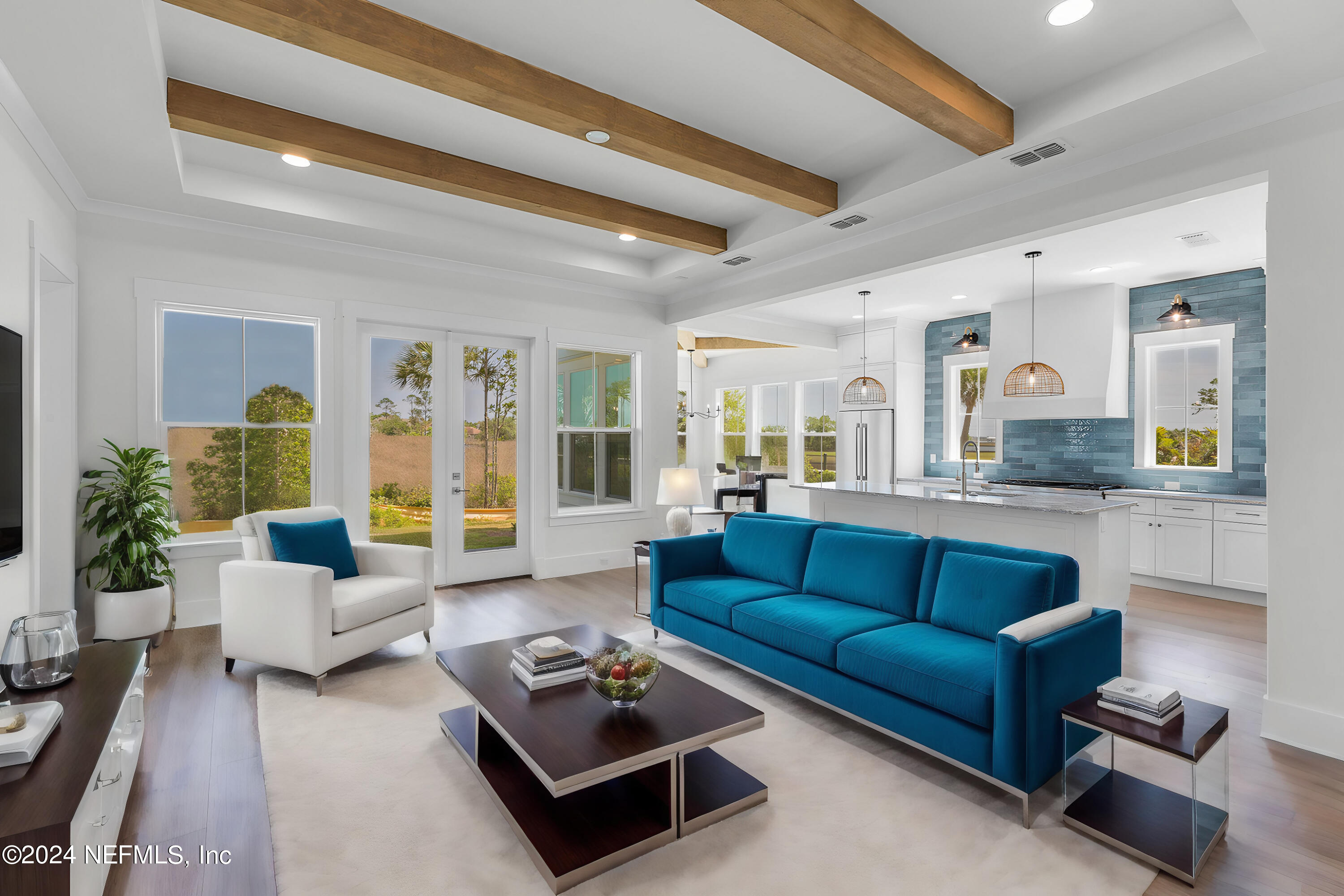 a living room with furniture rug and view of kitchen