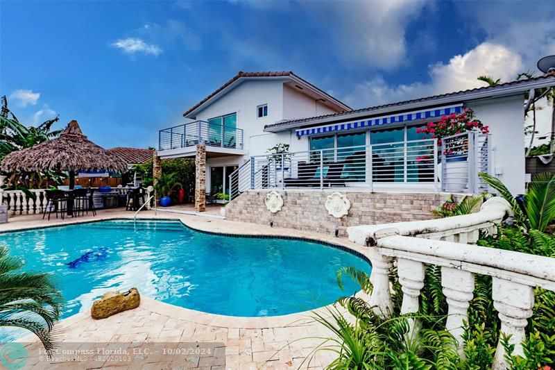 a view of a house with swimming pool and porch